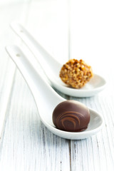 chocolate pralines in ceramic spoon
