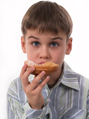 young boy eating donut