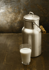 Metal milk can with glass of fresh milk