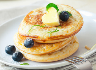 Stack of blinis or pancakes with blueberries