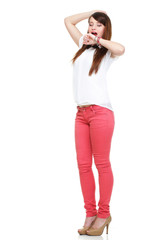 Beautiful standing yawning stretching woman in red