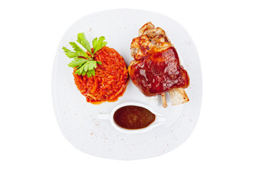 Grilled meat ribs with tomatoes chives and dark hot sauce