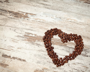 coffee beans in the form of heart on a wooden table