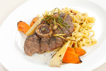tasty steak with pasta