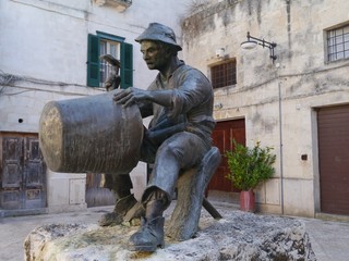 A statue of a tinker on a square in Matera in Italy