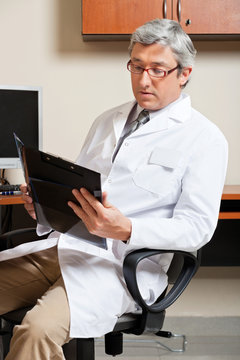 Mature Male Doctor Reading
