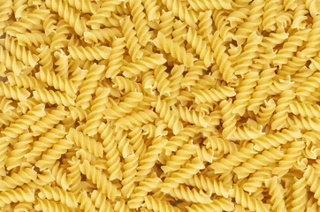 Some fusilli pasta as background pattern © putzlowitsch