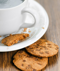 Coffee and oatmeal cookies on wooden table
