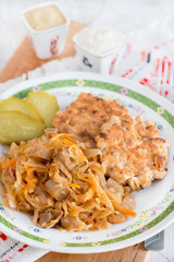 Stewed cabbage with mushrooms, chicken cutlets on side
