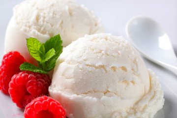 Scoops of creamy ice cream with raspberries