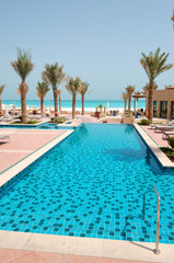 Fototapeta na wymiar Swimming pool at the beach of luxury hotel, Saadiyat island, Abu