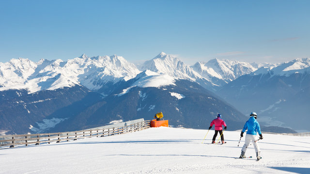 Skiers Enjoy a Sunny Day on the Mountains