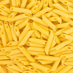 Italian Penne Rigate Macaroni Pasta raw food background or textu