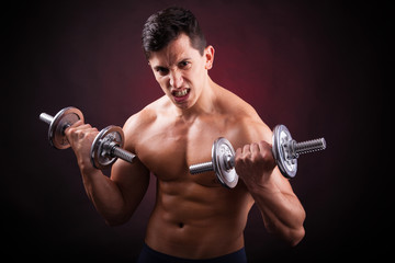 Fototapeta na wymiar Image of a muscular young man lifting weights on black backgroun