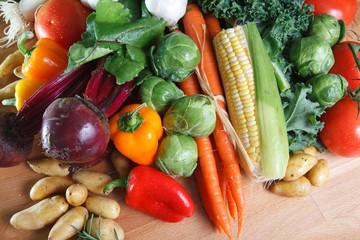 Group of colorful healthy vegetables on wood cutting board