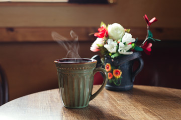 traditional mug of cofee on wooden cafe table