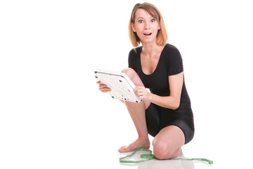 Caucasian young woman weight scale looking camera isolated white