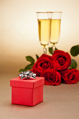 Champagne glasses, present and roses