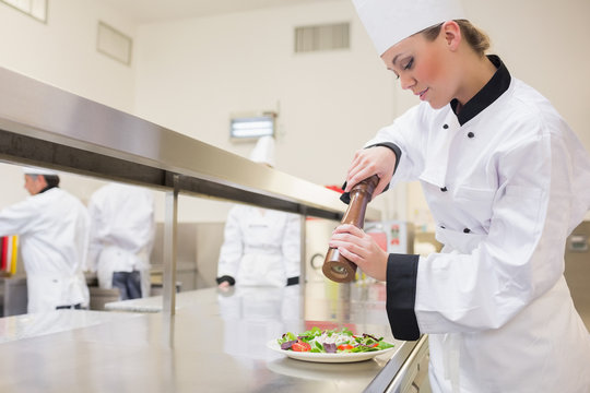 Chef Seasoning Salad With Pepper