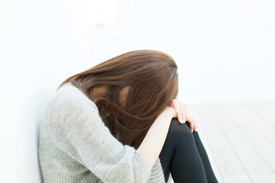 Beautiful Sad Woman Sittiing In The Room