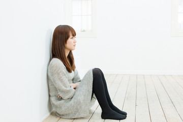 Beautiful sad woman sittiing in the room