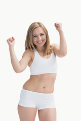 Portrait of an excited young woman in sportswear