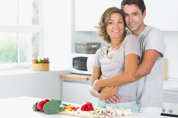 Obraz na płótnie Canvas Wife and husband embracing in the kitchen