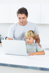 Father and son using laptop