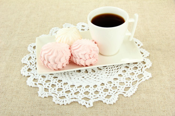 Marshmallows on plate on light background