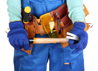 Fototapeta na wymiar Male builder in blue overalls with gavel isolated on white