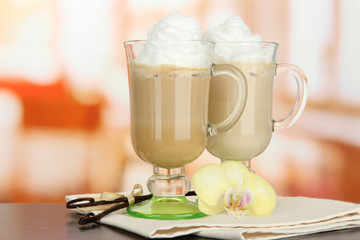 Fragrant coffee latte in glasses cups with vanilla pods,