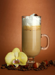 Fragrant coffee latte in glass cup with spices,
