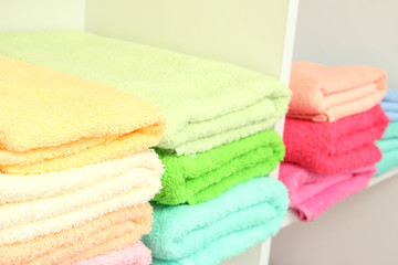 colorful towels on shelves in bathroom