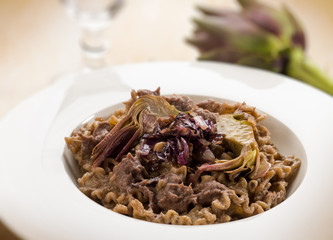 integral pasta with artichoke and chicory, selective focus