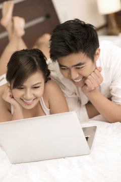 Happy lovers with laptop