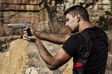 menacing man pointing a handgun