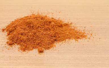 Pile of dried paprika  on wooden worktop