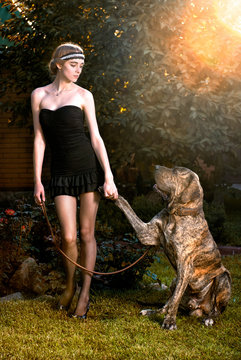 Happy elegant woman with big dog in autumn forest