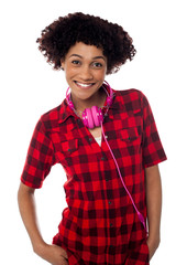 Stylish teenager with headphones around her neck