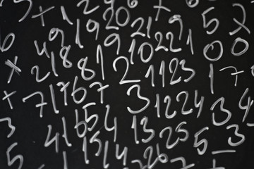 Random numbers written in chalk on a blackboard