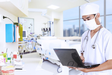 Doctor working with laptop
