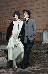 Retro styled fashion portrait of a young couple. Clothing and ma