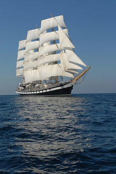Sailing frigate under full sail in the ocean