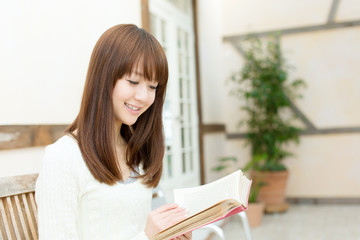 Beautiful young woman reading a book