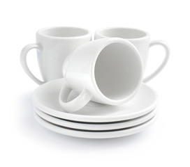 Empty white coffee cups and saucers on a white background