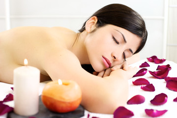 Fototapeta na wymiar Beautiful woman relaxing sleeping naked during massage in spa