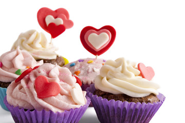 Four Valentine decorated cupcakes isolated on white - Powered by Adobe