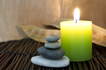 Fototapeta na wymiar Candle and stones at the spa