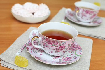 Romantic tea served in beautiful cups with marshmallow