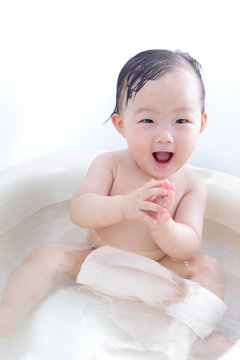 baby girl excited taking a relaxing bath